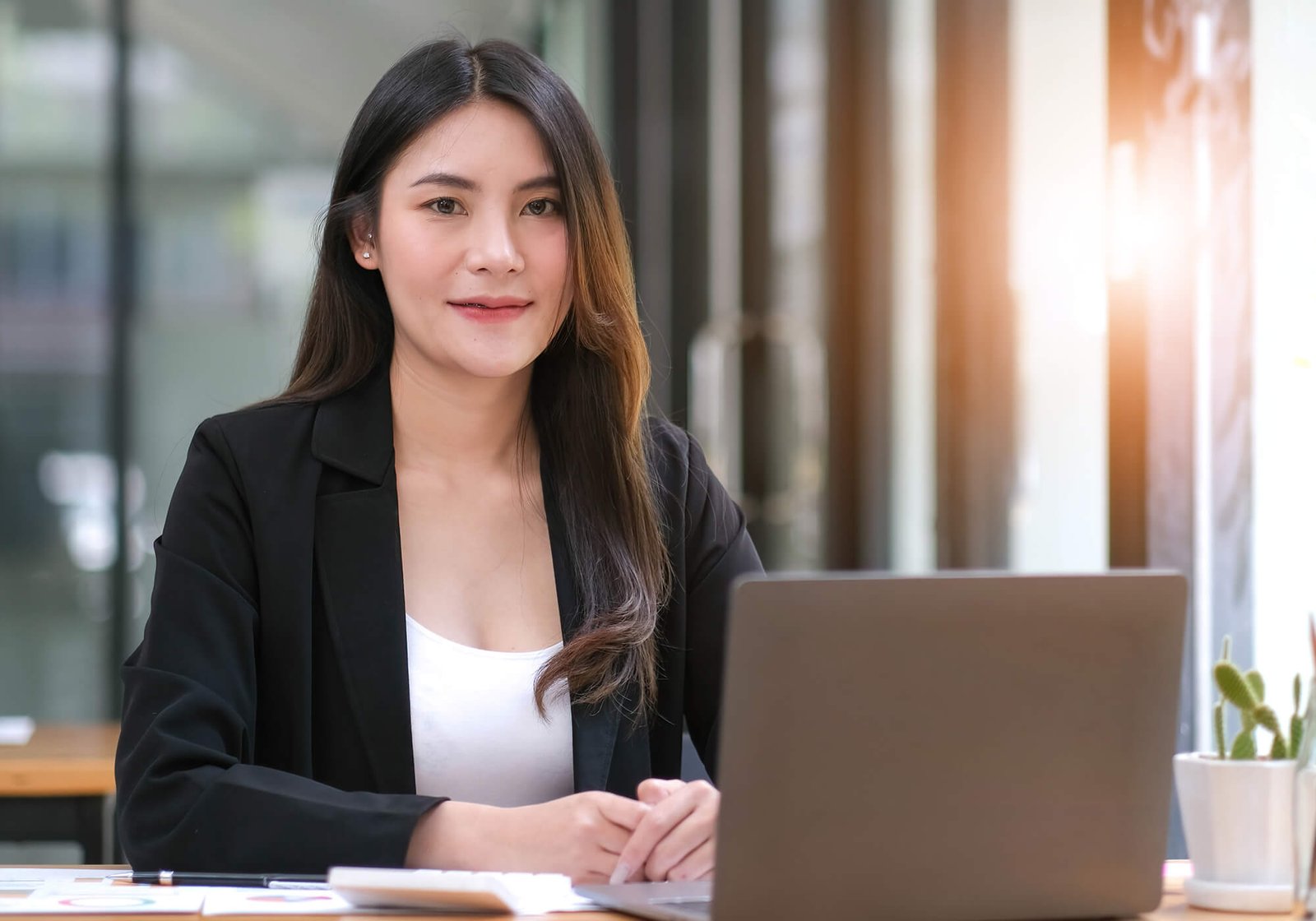 confident young asian business woman sitting with w45fjla.jpg